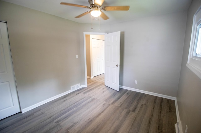 3745 Holly Ave, Flint, MI 48506 - unfurnished bedroom with wood finished floors and a ceiling fan