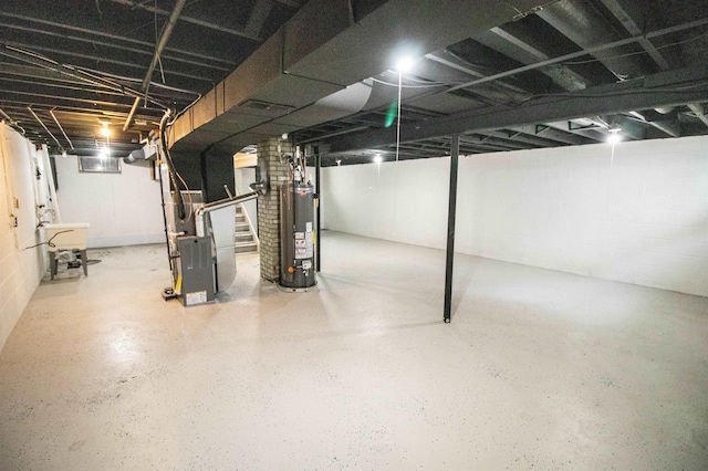 3745 Holly Ave, Flint, MI 48506 - basement featuring gas water heater, heating unit, and stairway