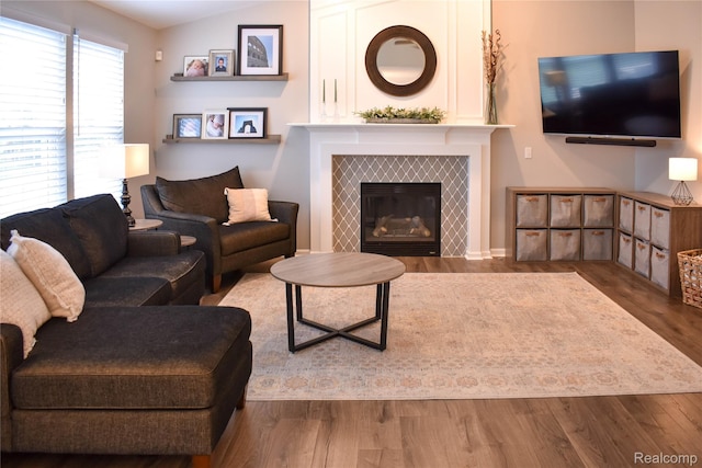 18006 Wingate Dr, Macomb, MI 48042 - living area featuring wood finished floors and a tile fireplace