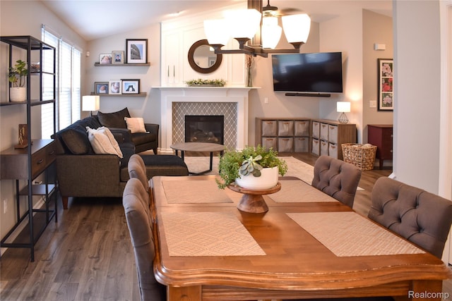 18006 Wingate Dr, Macomb, MI 48042 - dining area with wood finished floors, vaulted ceiling, a tiled fireplace, and a ceiling fan