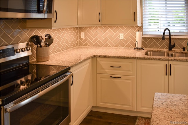 18006 Wingate Dr, Macomb, MI 48042 - kitchen with stainless steel appliances, white cabinetry, and light stone countertops