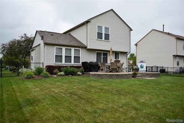 18006 Wingate Dr, Macomb, MI 48042 - rear view of house with a patio, a fenced backyard, and a shingled roof