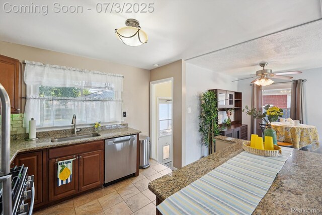 29934 Tamarack Dr, Gibraltar, MI 48134 - kitchen with appliances with stainless steel finishes, a ceiling fan, light tile patterned floors, and light stone counters