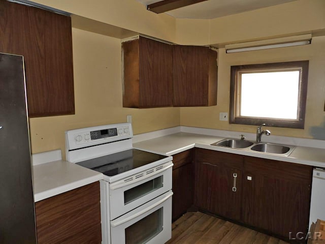 2171 Harold St, Adrian, MI 49221 - kitchen featuring white appliances, light countertops, dark wood-type flooring, and dark brown cabinetry