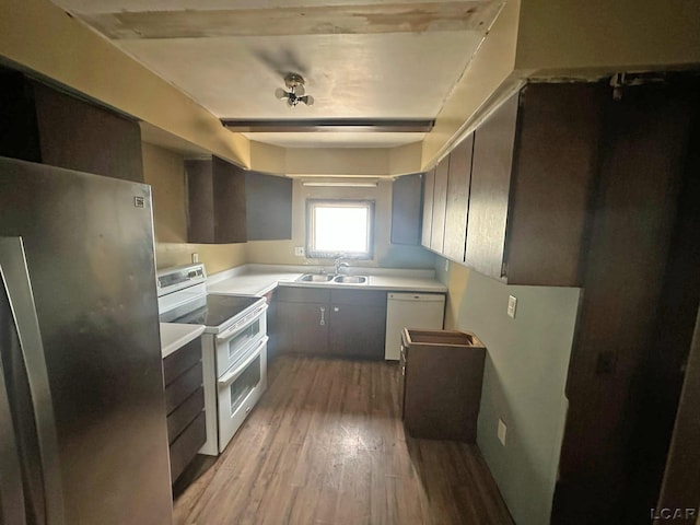 2171 Harold St, Adrian, MI 49221 - kitchen featuring white appliances, wood finished floors, light countertops, and beam ceiling