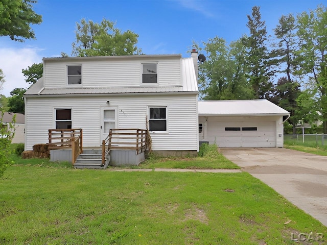 2171 Harold St, Adrian, MI 49221 - back of property featuring a garage, concrete driveway, a wooden deck, and a metal roof