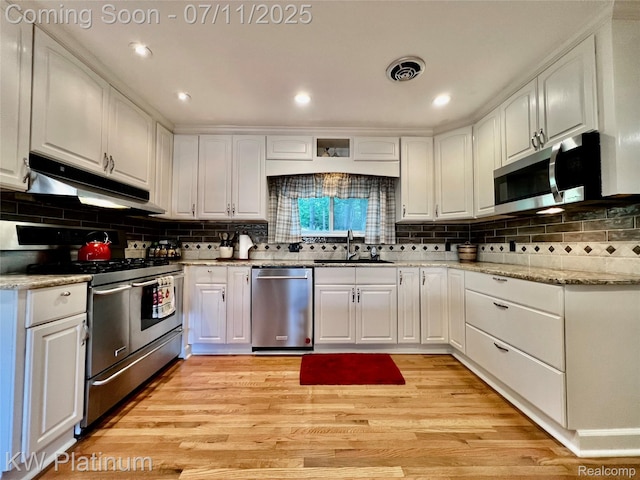 7135 Gardner Line Rd, Lexington, MI 48450 - kitchen featuring appliances with stainless steel finishes, under cabinet range hood, white cabinets, backsplash, and recessed lighting