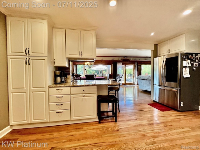 7135 Gardner Line Rd, Lexington, MI 48450 - kitchen featuring smart refrigerator, a peninsula, light wood-style floors, white cabinetry, and a breakfast bar