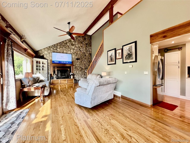 7135 Gardner Line Rd, Lexington, MI 48450 - living room with light wood-style floors, ceiling fan, a fireplace, beamed ceiling, and stairway