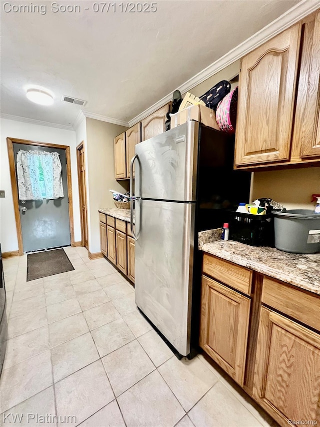 7135 Gardner Line Rd, Lexington, MI 48450 - kitchen featuring freestanding refrigerator, ornamental molding, light stone counters, and light tile patterned floors