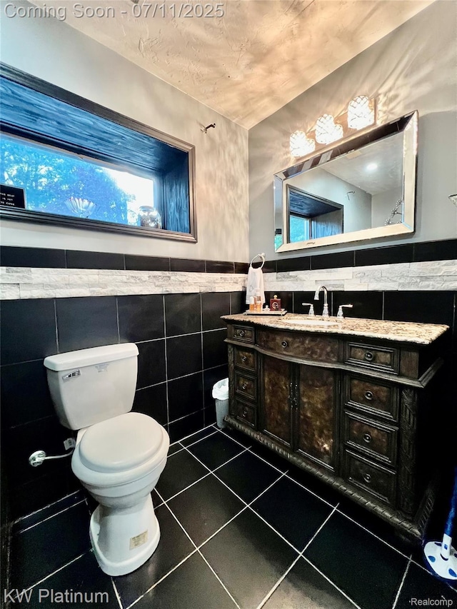 7135 Gardner Line Rd, Lexington, MI 48450 - bathroom with tile walls, vanity, tile patterned floors, and a wainscoted wall