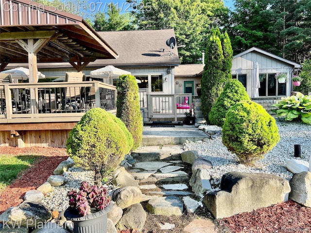 7135 Gardner Line Rd, Lexington, MI 48450 - view of front of property with a deck, a shingled roof, and a small pond