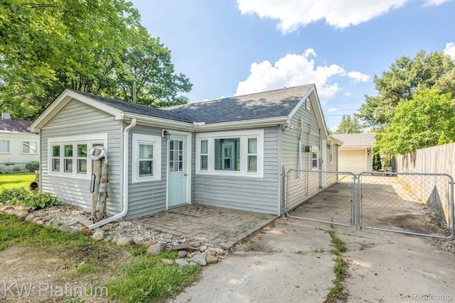 7377 Dogwood Rd, Lexington, MI 48450 - view of front of property with a gate, roof with shingles, and a detached garage