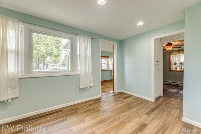 7377 Dogwood Rd, Lexington, MI 48450 - empty room featuring a baseboard heating unit, wood finished floors, recessed lighting, and ceiling fan