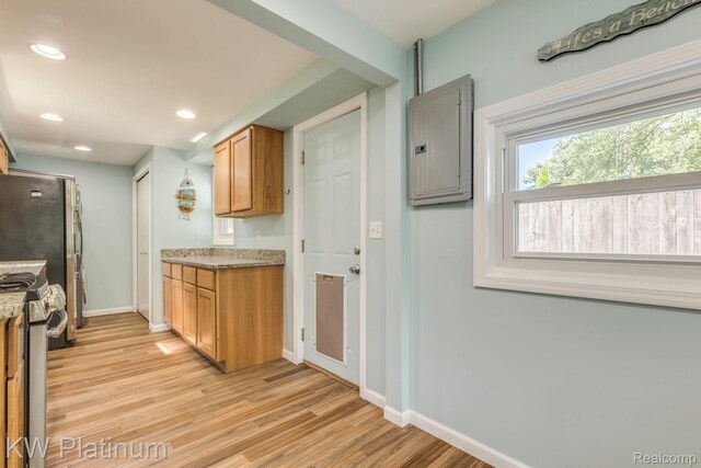 7377 Dogwood Rd, Lexington, MI 48450 - kitchen featuring stainless steel gas range, electric panel, light wood-style floors, recessed lighting, and light stone countertops