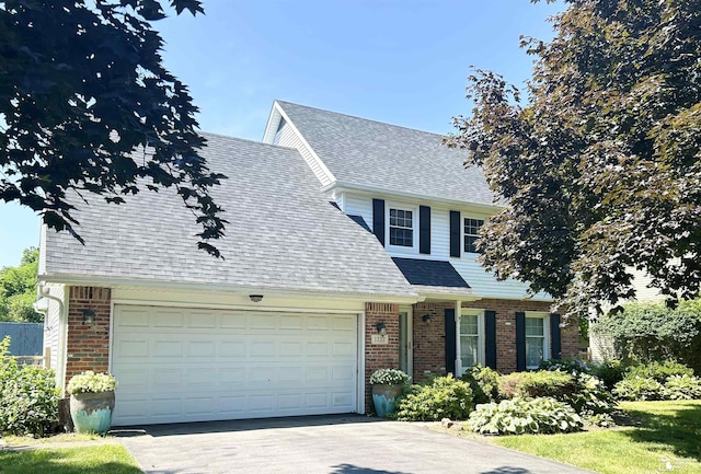 1727 Stoneybrook Ln, Temperance, MI 48182 - traditional home featuring brick siding, asphalt driveway, an attached garage, and a shingled roof