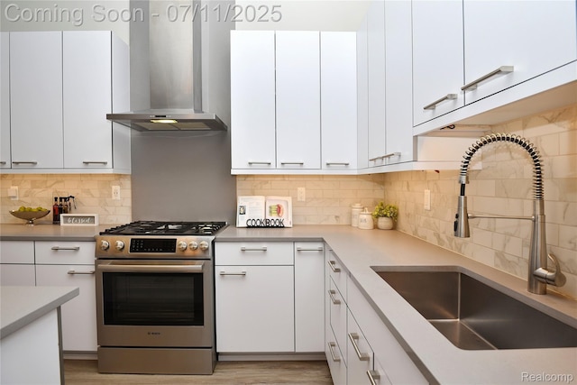 750 Forest Ave Unit 202, Birmingham, MI 48009 - kitchen featuring gas stove, range hood, tasteful backsplash, and white cabinets