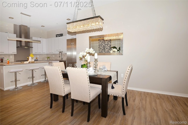750 Forest Ave Unit 202, Birmingham, MI 48009 - dining space with a chandelier and light wood-style flooring