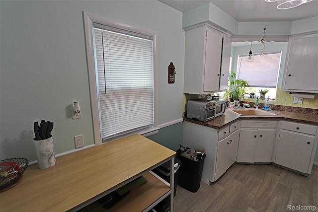 24271 Westhampton St, Oak Park, MI 48237 - kitchen featuring white cabinets, wood finished floors, and dark countertops