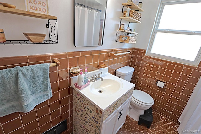 24271 Westhampton St, Oak Park, MI 48237 - full bathroom with tile walls, vanity, wainscoting, tile patterned floors, and a shower with curtain