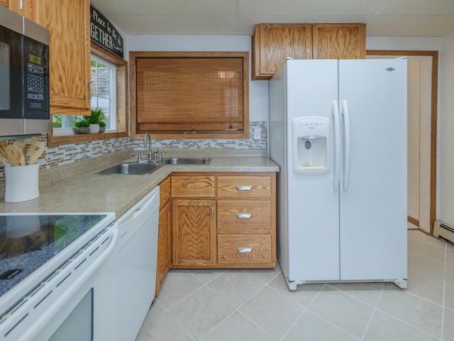 44850 Woodman Dr, Paw Paw, MI 49079 - kitchen featuring white appliances, decorative backsplash, light countertops, and light tile patterned floors