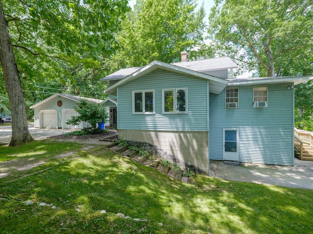 44850 Woodman Dr, Paw Paw, MI 49079 - view of side of property with a yard, cooling unit, a garage, and a chimney