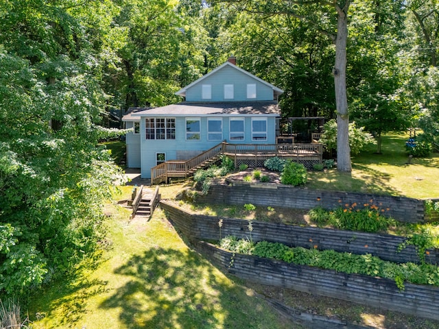 44850 Woodman Dr, Paw Paw, MI 49079 - back of house featuring a deck, a lawn, stairway, and a chimney