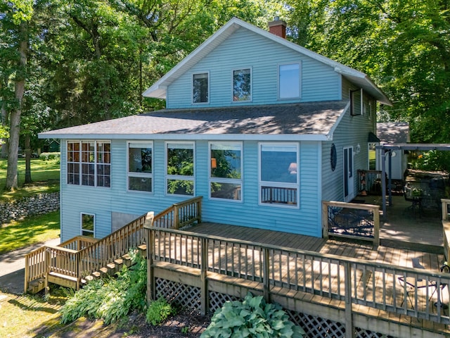 44850 Woodman Dr, Paw Paw, MI 49079 - back of house with roof with shingles, a chimney, a deck, and stairs