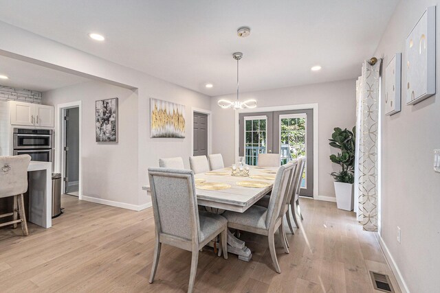 607 S State St, Hart, MI 49420 - dining space with light wood-type flooring, a chandelier, french doors, and recessed lighting