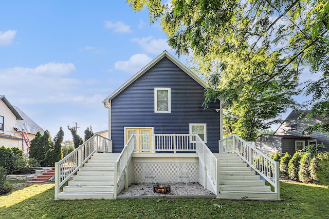 607 S State St, Hart, MI 49420 - rear view of house featuring stairway, a yard, and a wooden deck