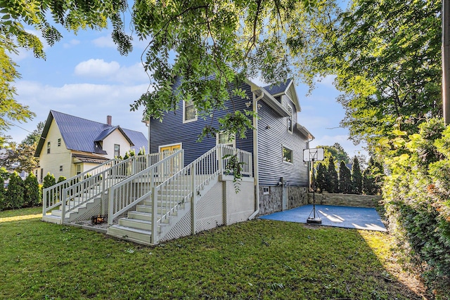 607 S State St, Hart, MI 49420 - back of property featuring stairs, a patio area, a yard, and a wooden deck