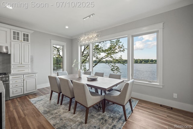 1760 Hamilton Dr, Bloomfield Hills, MI 48302 - dining space featuring a chandelier, dark wood finished floors, a water view, recessed lighting, and ornamental molding