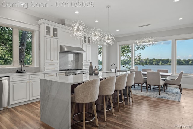 1760 Hamilton Dr, Bloomfield Hills, MI 48302 - kitchen featuring wall chimney range hood, a chandelier, healthy amount of natural light, a center island with sink, and recessed lighting