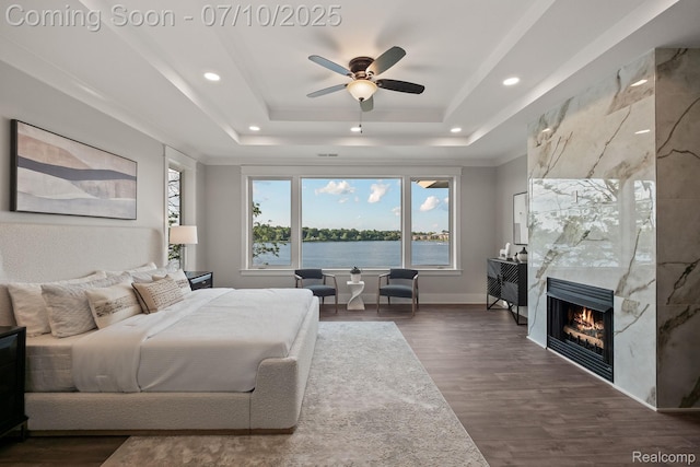 1760 Hamilton Dr, Bloomfield Hills, MI 48302 - bedroom with a tray ceiling, dark wood-style floors, a large fireplace, a water view, and recessed lighting