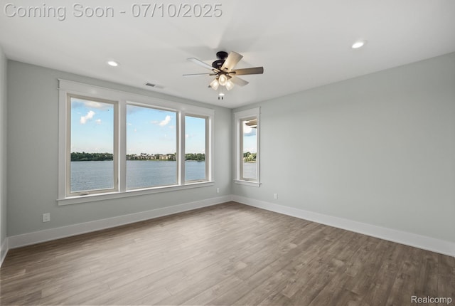 1760 Hamilton Dr, Bloomfield Hills, MI 48302 - empty room with a ceiling fan, wood finished floors, a water view, and recessed lighting