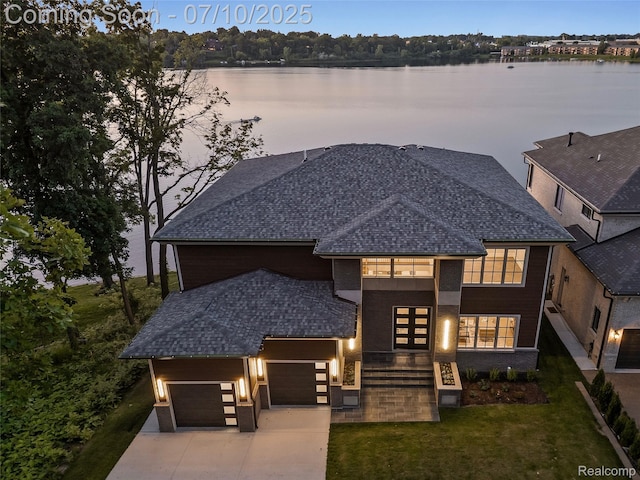 1760 Hamilton Dr, Bloomfield Hills, MI 48302 - view of front of house featuring an attached garage, a shingled roof, a front lawn, concrete driveway, and a water view