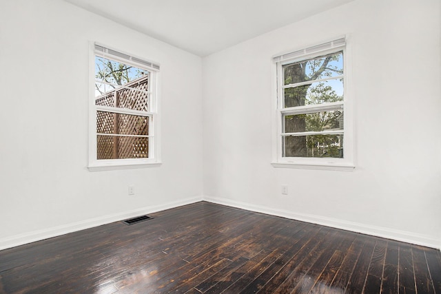 46 N 31st St, Battle Creek, MI 49015 - spare room featuring dark wood-style floors and baseboards