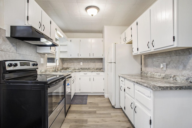 46 N 31st St, Battle Creek, MI 49015 - kitchen with range with electric stovetop, under cabinet range hood, tasteful backsplash, and white cabinetry