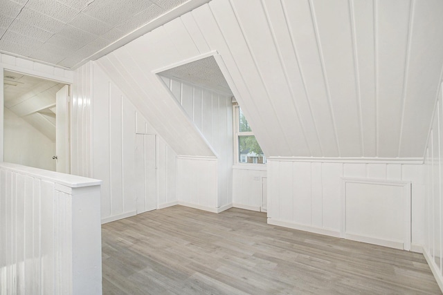 46 N 31st St, Battle Creek, MI 49015 - bonus room with lofted ceiling, wood finished floors, and a decorative wall