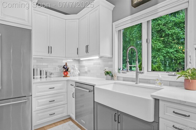 2545 Hartun Dr, Brighton, MI 48114 - kitchen featuring stainless steel appliances, plenty of natural light, tasteful backsplash, and light countertops