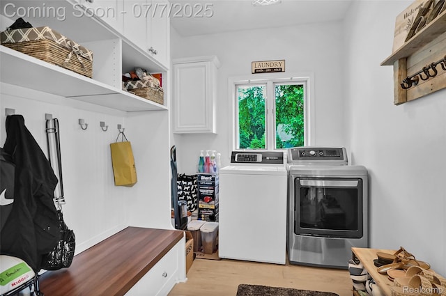 2545 Hartun Dr, Brighton, MI 48114 - laundry area featuring cabinet space, washing machine and dryer, and light wood-style flooring