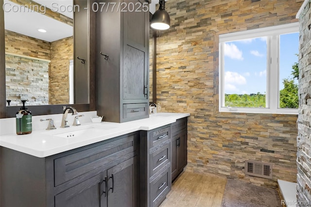 2545 Hartun Dr, Brighton, MI 48114 - full bath with double vanity and wood finished floors
