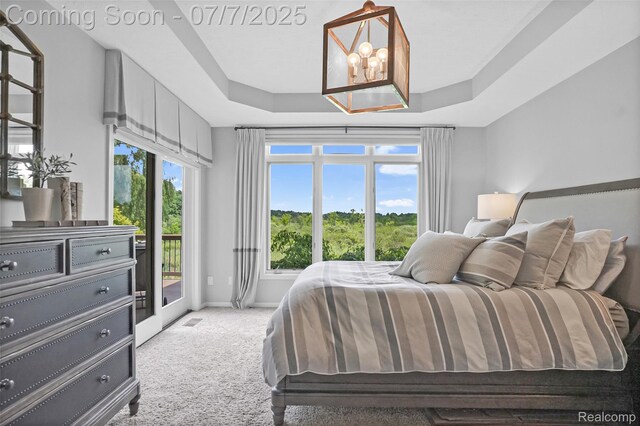 2545 Hartun Dr, Brighton, MI 48114 - carpeted bedroom featuring access to exterior, a chandelier, and a tray ceiling