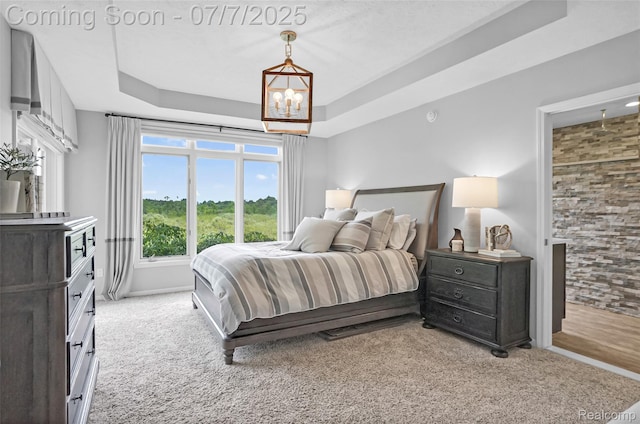 2545 Hartun Dr, Brighton, MI 48114 - bedroom featuring light carpet, a chandelier, and a raised ceiling