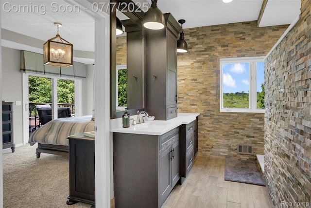 2545 Hartun Dr, Brighton, MI 48114 - bathroom featuring vanity, tiled shower, and wood finished floors