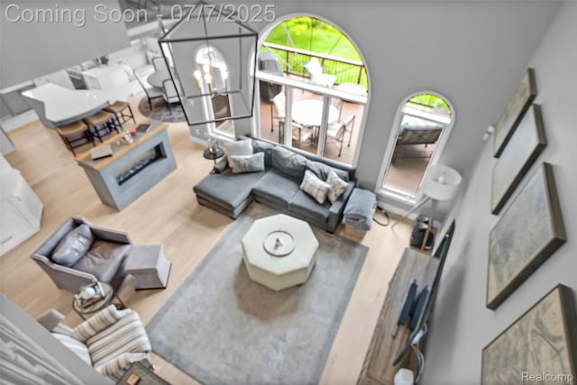 2545 Hartun Dr, Brighton, MI 48114 - living area featuring wood finished floors and a chandelier