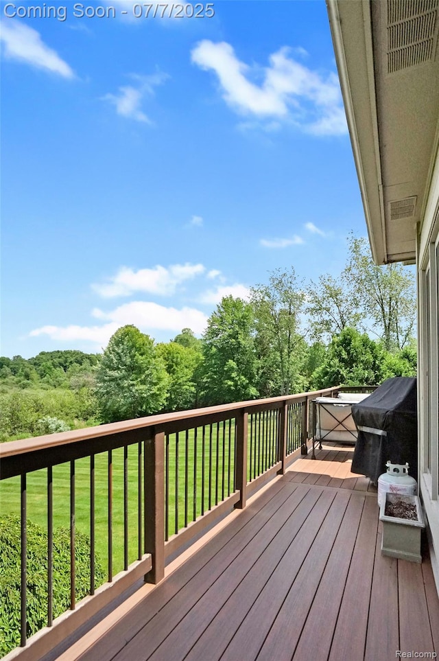 2545 Hartun Dr, Brighton, MI 48114 - deck featuring grilling area, a lawn, and a forest view