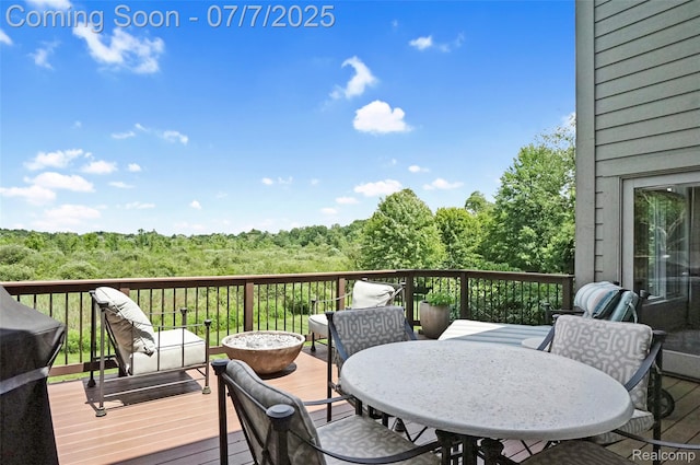 2545 Hartun Dr, Brighton, MI 48114 - wooden terrace with a wooded view and outdoor dining space