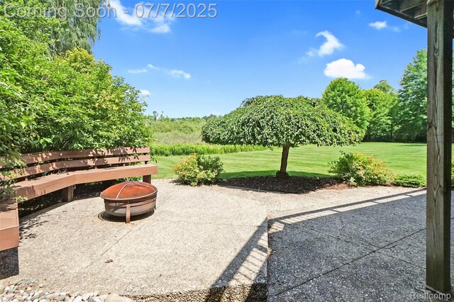 2545 Hartun Dr, Brighton, MI 48114 - view of patio / terrace with an outdoor fire pit