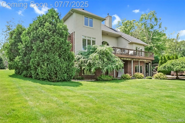 2545 Hartun Dr, Brighton, MI 48114 - rear view of house featuring a wooden deck, brick siding, a lawn, and a chimney
